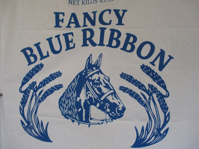 May include: Blue and white logo with the text "Fancy Blue Ribbon" and a stylized image of a horse's head with wheat stalks on either side.