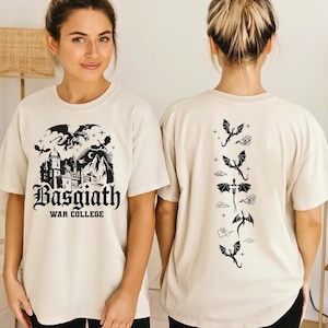 A woman wearing a white t-shirt with a graphic design featuring a castle and dragons.