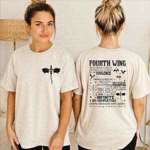 A woman wearing a white t-shirt with a dragon design on the front and text on the back.