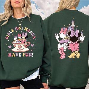 a woman wearing a sweatshirt with minnie mouse on it