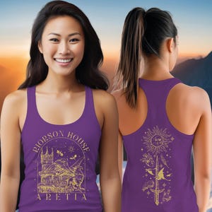 A smiling woman wearing a purple tank top with a graphic design on the front and back.