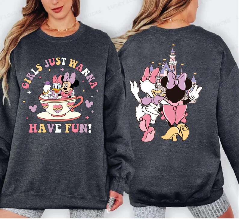 A gray sweatshirt with a graphic design featuring Minnie Mouse and Mickey Mouse in a cup, along with the text "Girls just wanna have fun!"
