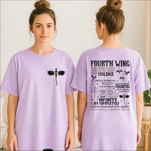 A woman wearing a purple t-shirt with a dragon design and text printed on the back.