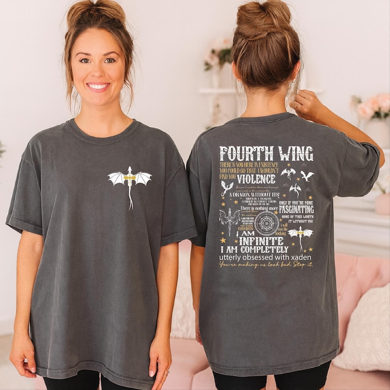 A woman wearing a gray t-shirt with a dragon design and text printed on the back.