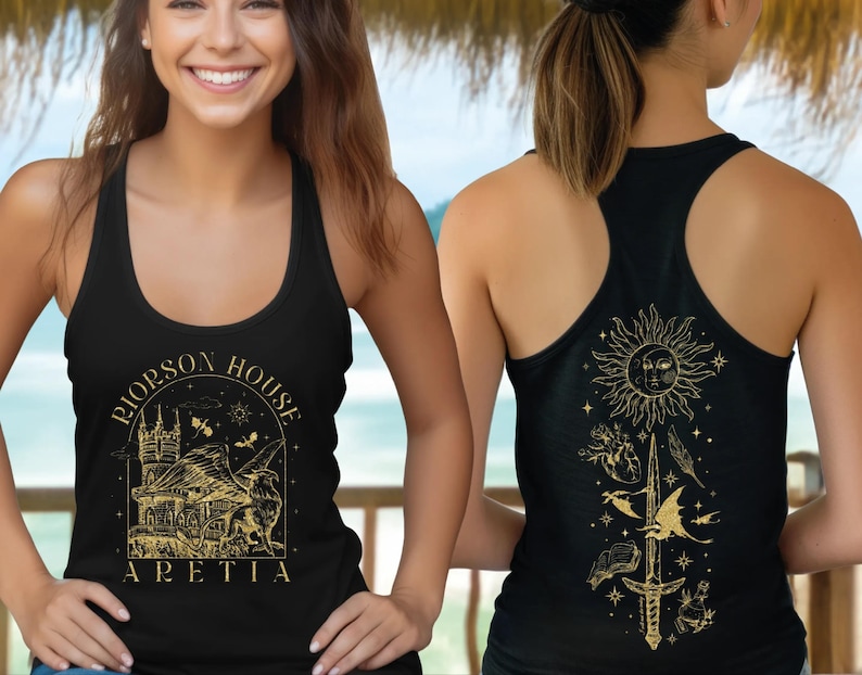 A smiling woman wearing a black tank top with a graphic design on the front and a back design on the back.