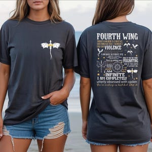 a woman wearing a black t-shirt with a graphic design and text on the back.