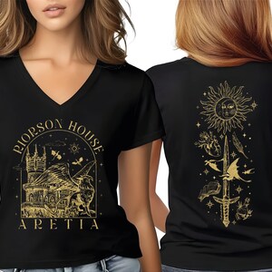 A woman wearing a black t-shirt with a gold graphic design on the front and back.