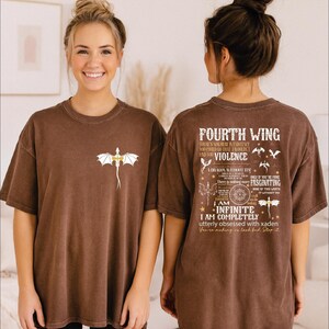 A woman wearing a brown t-shirt with a dragon design and text on the back.