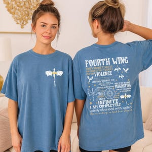 A woman wearing a blue t-shirt with a dragon design and text on the back.