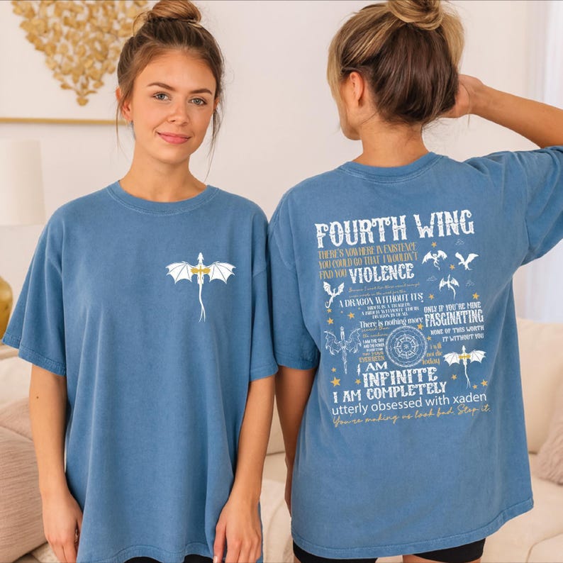 A woman wearing a blue t-shirt with a dragon design and text on the back.