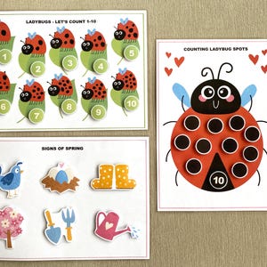 K&ouml;nnte beinhalten: Ein Satz von drei druckbaren Lernspielkarten f&uuml;r Kinder mit Marienk&auml;fern. Die erste Karte zeigt Marienk&auml;fer mit den Zahlen 1-10. Die zweite Karte zeigt einen Marienk&auml;fer mit 10 Punkten zum Z&auml;hlen. Die dritte Karte zeigt Bilder von Fr&uuml;hlingszeichen, darunter einen Vogel, ein Nest mit Eiern, Stiefel, eine Blume, eine Schaufel und eine Gie&szlig;kanne.