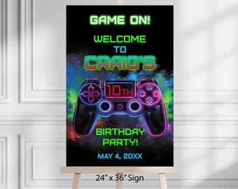 May include: A neon green, blue, and pink birthday party sign with a video game controller graphic and the text "GAME ON! WELCOME TO CRAIG'S 10TH BIRTHDAY PARTY! MAY 4, 20XX 24" x 36" Sign".
