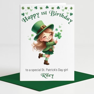 May include: A St. Patrick's Day themed birthday card. The card features a cartoon girl dressed in green, holding a shamrock. The text reads "Happy 1st Birthday" and "to a special St. Patrick's Day girl".