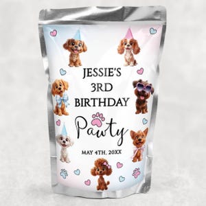 May include: A silver pouch with a design for a dog's 3rd birthday. The design includes illustrations of puppies wearing party hats and sunglasses, with the text "Jessie's 3rd Birthday Pawty" and the date.