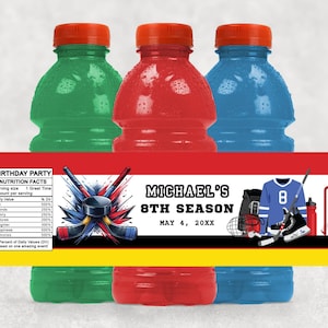 May include: Three sports drink bottles in green, red, and blue, with orange caps. A banner across the bottles reads "Michael's 8th Season" with hockey-themed graphics and a nutrition facts label. The date "May 4, 20XX" is also displayed.