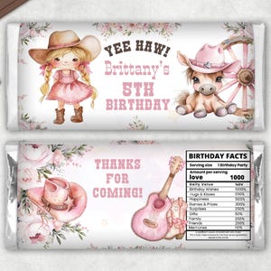 May include: A pink and white chocolate bar wrapper with a cowgirl theme. The wrapper features a cartoon cowgirl with blonde hair wearing a pink hat and dress. The text on the wrapper reads "Yee Haw! Brittany's 5th Birthday" and "Thanks for Coming!"  The back of the wrapper has a list of "Birthday Facts" with a pink and white floral design.