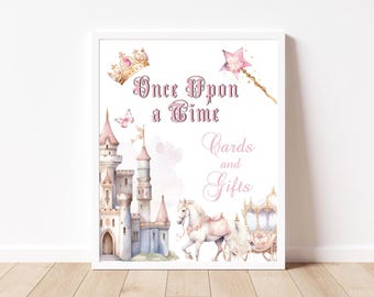 Puede incluir: Una impresión en acuarela enmarcada con un tema de cuento de hadas. La obra de arte presenta un castillo rosa, un carruaje tirado por caballos y el texto "Once Upon a Time Cards and Gifts". También se representa una corona, una varita mágica y una mariposa.