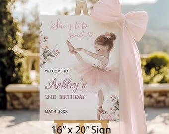 May include: A sign for Ashley's 2nd birthday, featuring a ballerina illustration in pink and white. The sign is 16" x 20" and includes the text "She's tutu sweet" and "Welcome to Ashley's 2nd Birthday". A large pink bow adorns the easel.