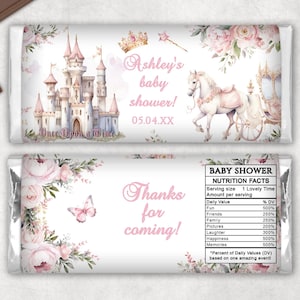May include: Two chocolate bar wrappers with a baby shower theme. One features a castle, horse-drawn carriage, and text "Ashley's baby shower!" The other says "Thanks for coming!" with floral and butterfly accents.