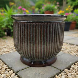 May include: A set of three ceramic mugs with a speckled, matte finish in cream, light grey, and dark grey. Each mug has a minimalist design and a rounded handle. Suitable for tea or coffee.