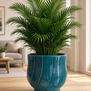 May include: A lush green palm plant with long, feathery fronds potted in a large, glossy teal ceramic planter. The planter features a rounded, bulbous shape with vertical, swirling embossed grooves that create a textured, reflective surface.