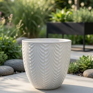 May include: A white ceramic planter featuring a repeating vertical herringbone or leaf-like embossed pattern across its exterior surface. The pot has a wide, circular opening and a tapered base, showcasing a clean, glossy finish throughout.