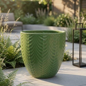May include: A glossy, vibrant green ceramic planter featuring a repeating vertical leaf-like texture embossed across its rounded exterior. The vessel has a wide, open circular rim and a tapered base, showcasing a consistent glazed finish throughout.