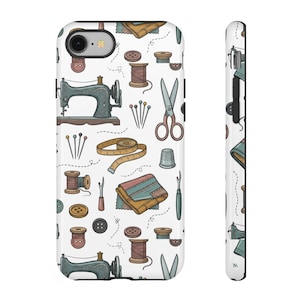 May include: A white phone case featuring a repeating pattern of sewing supplies including teal vintage sewing machines, brown spools of thread, silver scissors, needles, a yellow measuring tape, a metal thimble, and assorted buttons.