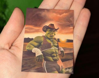 May include: A green, cartoon character wearing a cowboy hat and a brown, lacy bra. The character is standing in a field with a sunset in the background. The character is smiling and has a muscular physique.