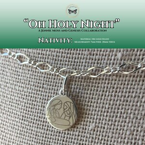 May include: A silver chain necklace with a round pendant featuring an engraved image of the nativity scene. The pendant is 0.7 inches wide and 1.4 inches thick. The text "OH HOLY NIGHT" and "NATIVITY" is also included in the image.