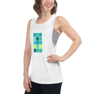 May include: White muscle tank top with a geometric design of teal, blue, and green squares.