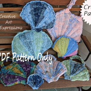 May include: A collection of crocheted seashells in various colors, including blue, pink, green, and purple. The shells are arranged on a wooden bench. The text "PDF Pattern Only" and "Crochet Pattern" are visible in the image.
