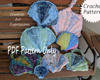 May include: A collection of crocheted seashells in various colours, including blue, pink, green, and purple. The shells are arranged on a wooden bench. The text "PDF Pattern Only" and "Crochet Pattern" are visible in the image.