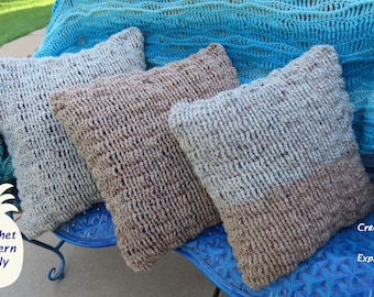 May include: Three crocheted throw pillows in various shades of brown and gray, sitting on a blue bench. The pillows have a textured, open-weave design.  "Crochet Pattern Only" is written in white text on a pineapple graphic.