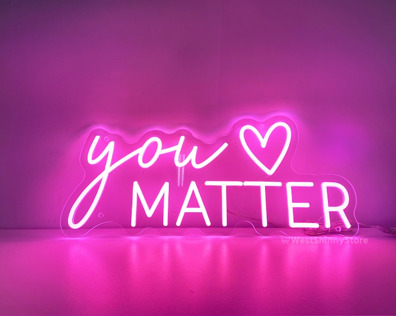 May include: Pink neon sign with the text "you &hearts; matter" in white neon lettering.