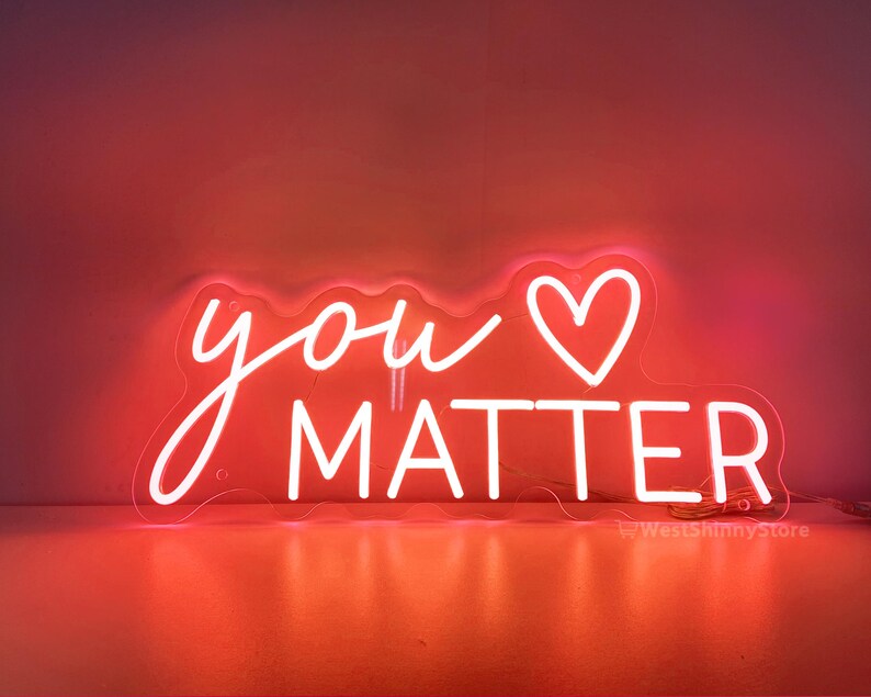 May include: Neon sign with the words "you" and a heart symbol, followed by the word "matter". The sign is white and glows pink.