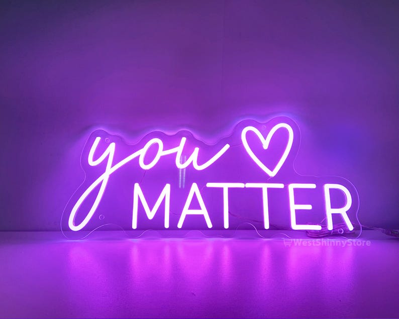 May include: A neon sign with a purple glow that reads "you &hearts; matter".