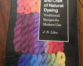 May include: A book titled "The Art and Craft of Natural Dyeing: Traditional Recipes for Modern Use" by J.N. Liles. The cover features a colorful display of yarn skeins in various shades of red, pink, purple, blue, green, and yellow.