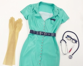 May include: A teal blue latex dress with a white collar, short sleeves, and a black belt. The dress has silver studs down the front. There are two pairs of long, beige latex gloves, a stethoscope, a pair of glasses, and a syringe with a red liquid.