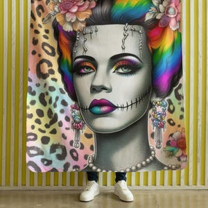 May include: A colourful throw blanket featuring a close-up portrait of a woman with rainbow hair and a leopard print background.