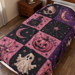 May include: A quilted bedspread featuring a patchwork pattern of black and pink squares. The design includes illustrations of a skull, a crescent moon, a potion bottle labelled Witches Brew, a spider web, a jack-o'-lantern, and a ghost with stars.