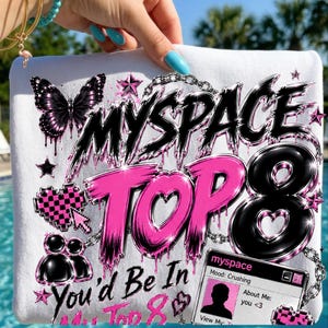 May include: A white sweatshirt featuring a graphic print with the text "MYSPACE TOP 8" and "You'd Be In My Top 8". The design includes a black butterfly, a pink checkered heart, a chain motif, and a digital profile box displaying "Mood: Crushing".
