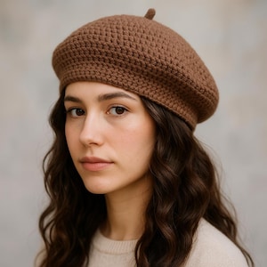 May include: A brown crochet beret with a textured surface. The beret is a classic style, perfect for adding a touch of elegance to any outfit. The hat is made of a soft, warm material, ideal for cooler weather.