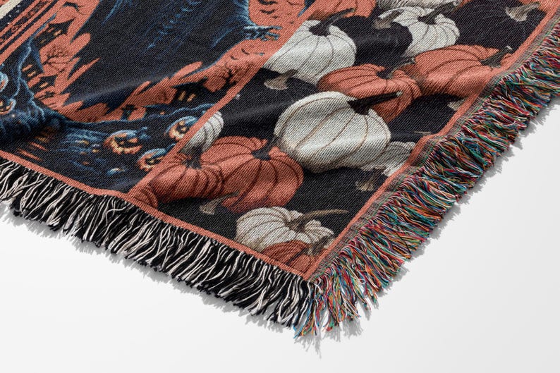 May include: Woven Halloween throw blanket featuring a repeating pattern of pumpkins in shades of orange and white against a black background. The blanket has a fringed edge with multiple colors. The design includes a spooky scene.
