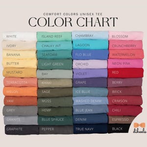 May include: Color chart showing 24 different colors of unisex t-shirts. The colors are arranged in rows and columns, with the names of each color listed below each swatch.