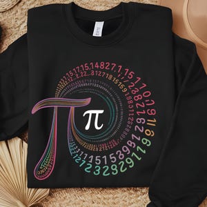 May include: Black sweatshirt with a colorful graphic of the mathematical constant pi, represented by the Greek letter &pi;, surrounded by a spiral of numbers.