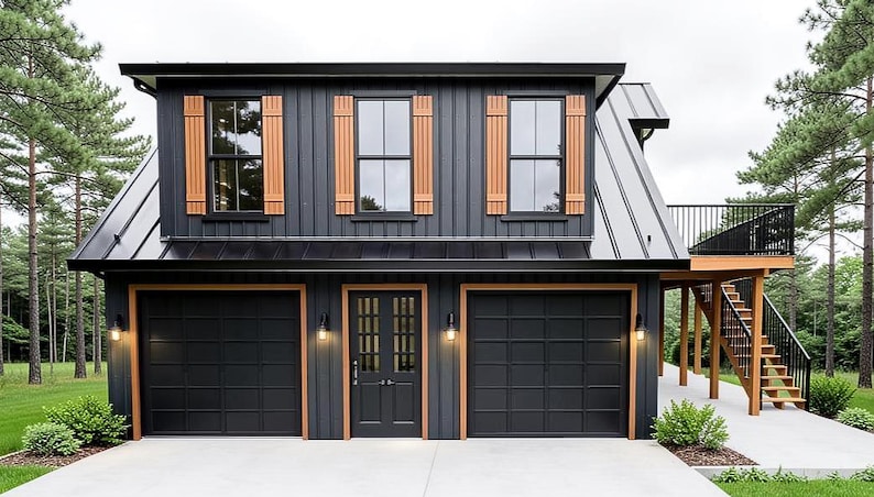 May include: A two-story, modern garage with a black exterior and natural wood accents. The garage features three black garage doors, a black front door, and wooden shutters. A balcony with stairs is visible on the side. The building is surrounded by trees.