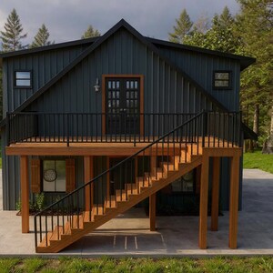 May include: A modern, two-story cabin with a dark teal exterior and a wooden deck. The cabin features a black railing, a wooden staircase, and a concrete patio. The surrounding area is filled with green grass and tall trees.