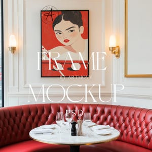May include: A framed illustration of a woman playing pool, with a red background and the text "FRAME BY ARTMOVV" below the image. The frame is hanging on a white wall above a red leather booth with a round table and chairs.