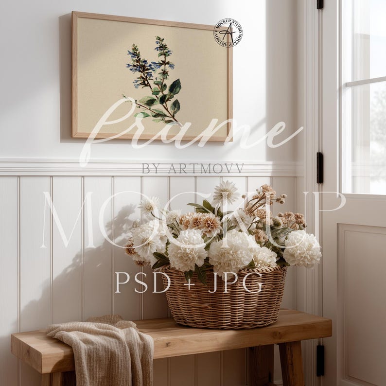 May include: A framed botanical print featuring blue and green flowers hangs above a wooden bench. A woven basket filled with white and tan flowers sits on the bench, with a folded beige blanket. The image is a mockup.